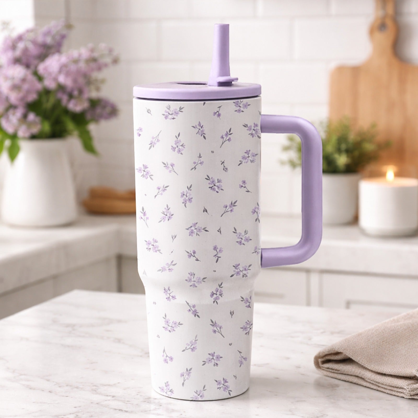 A 40-Ounce Stainless Steel Cup with a Handle And Flip-Top Straw Design, Featuring a Floral Pattern. It Fits Most Cup Holders, Has a Splash-Proof Structure, a Non-Slip Base, And Is Double-Walled for Both Hot And Cold Use. Reusable
